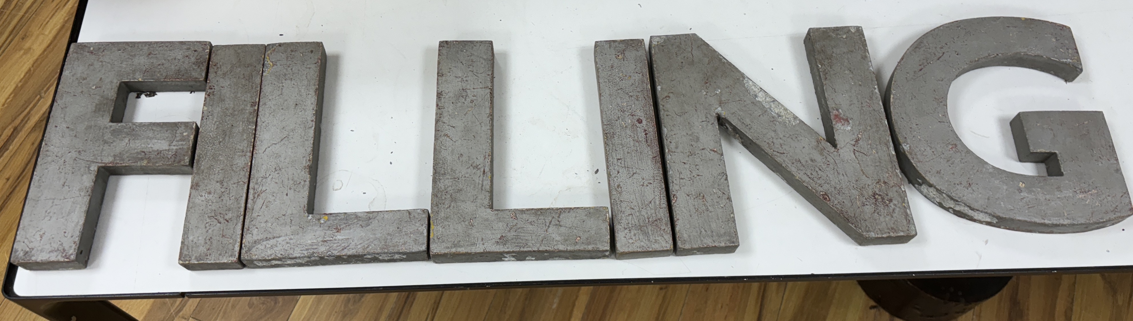 A collection of large metal letters spelling ' Filling Station' letters 23cm high (14)